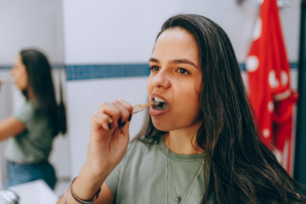 Woman brushing her teeth.